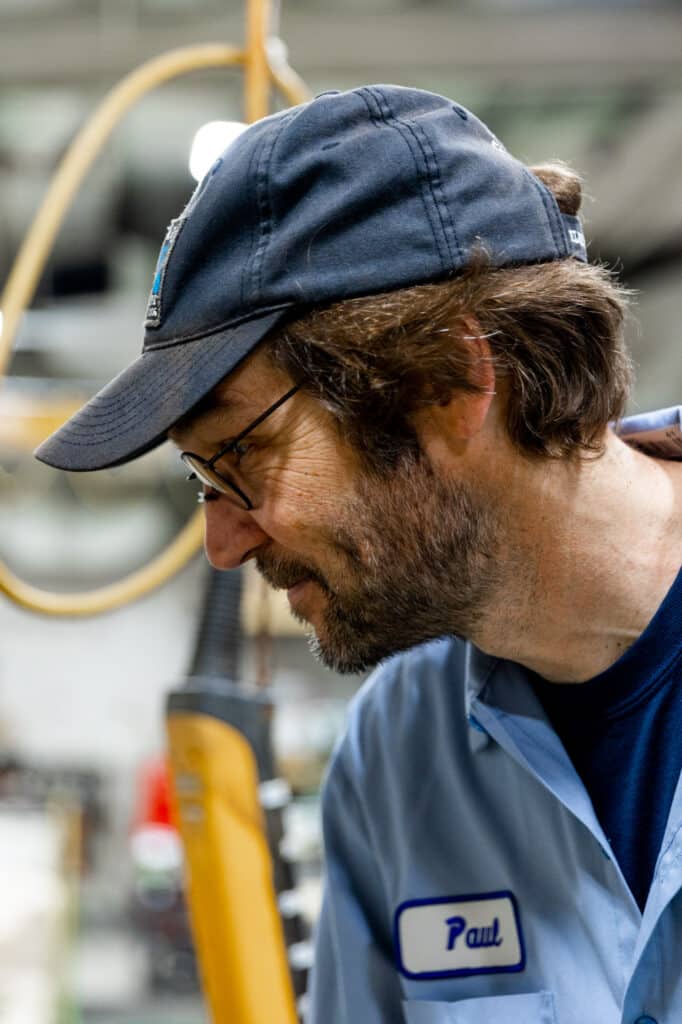 Plating technician observing metal coating tank
