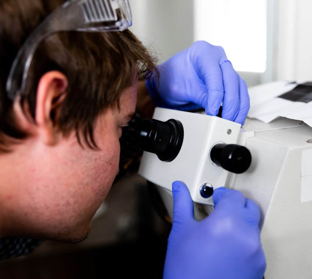 armoloy corporate lab chemist viewing thin dense chrome surface texture