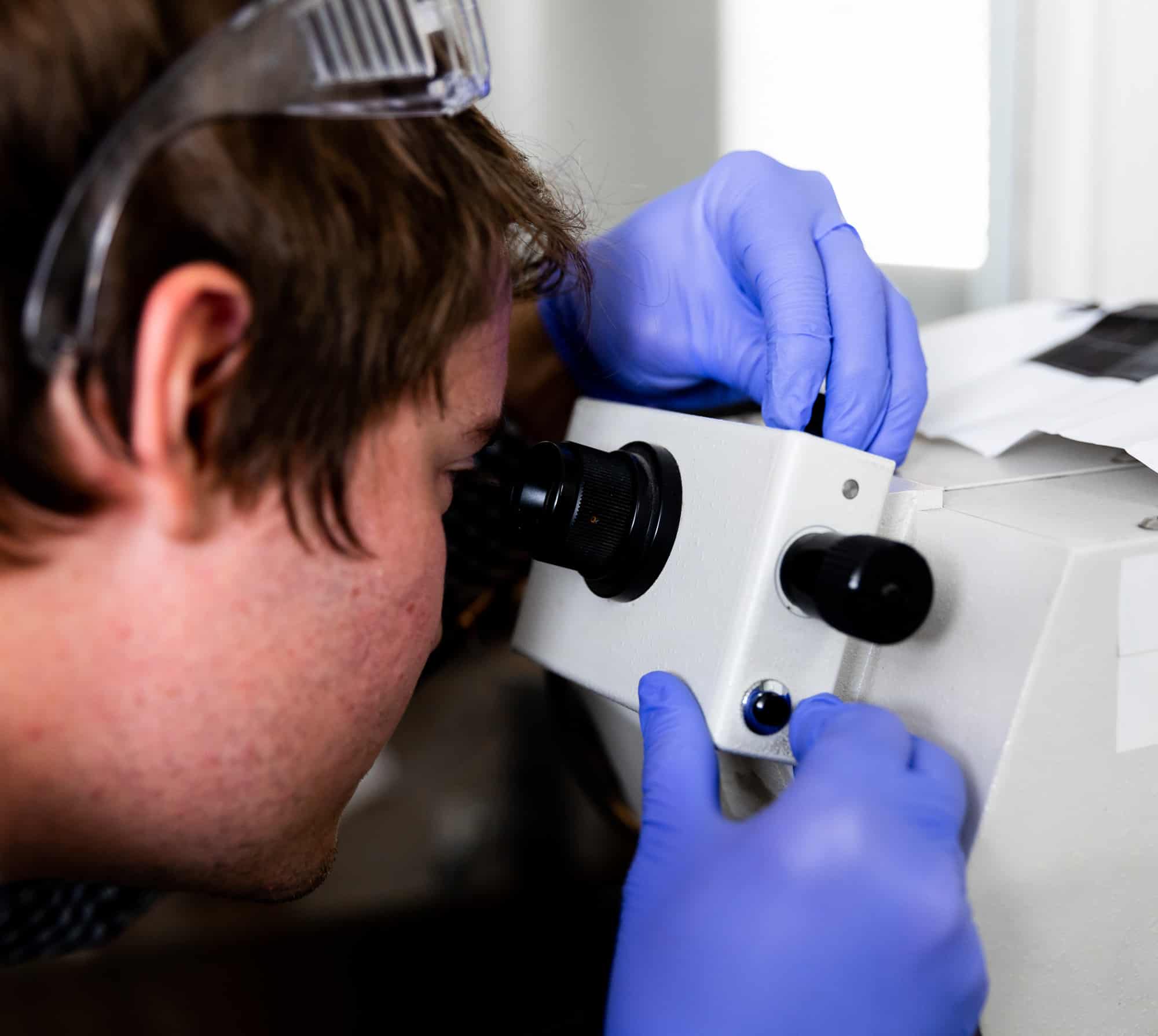 armoloy corporate lab chemist viewing thin dense chrome surface texture
