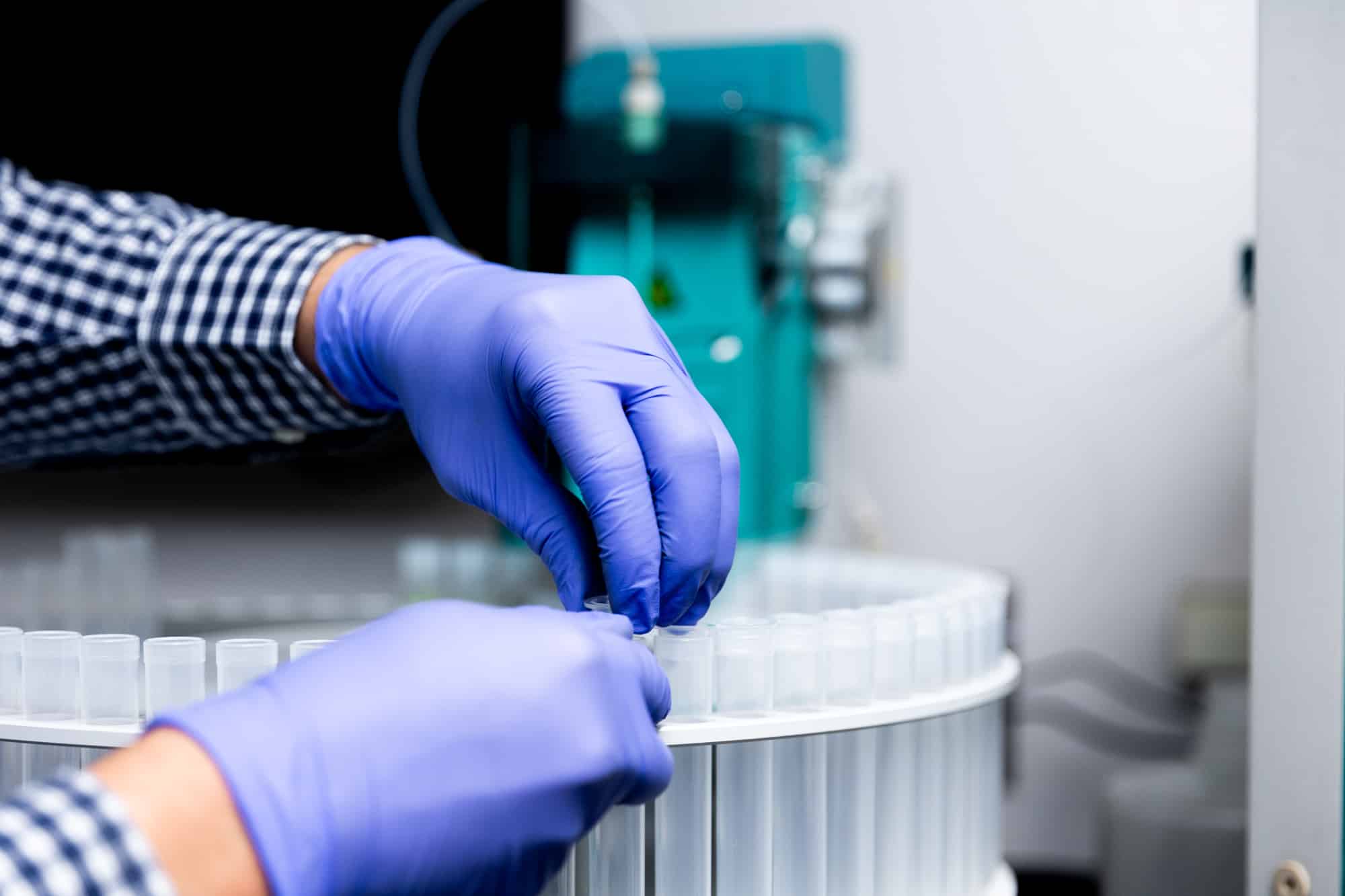 Chemist testing metal coating sample
