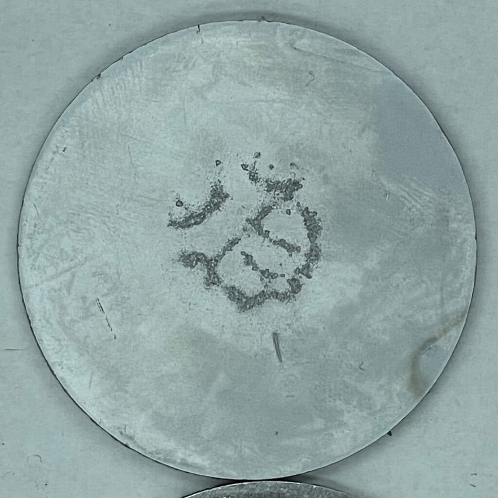 cavitation damage shown on metal coupon