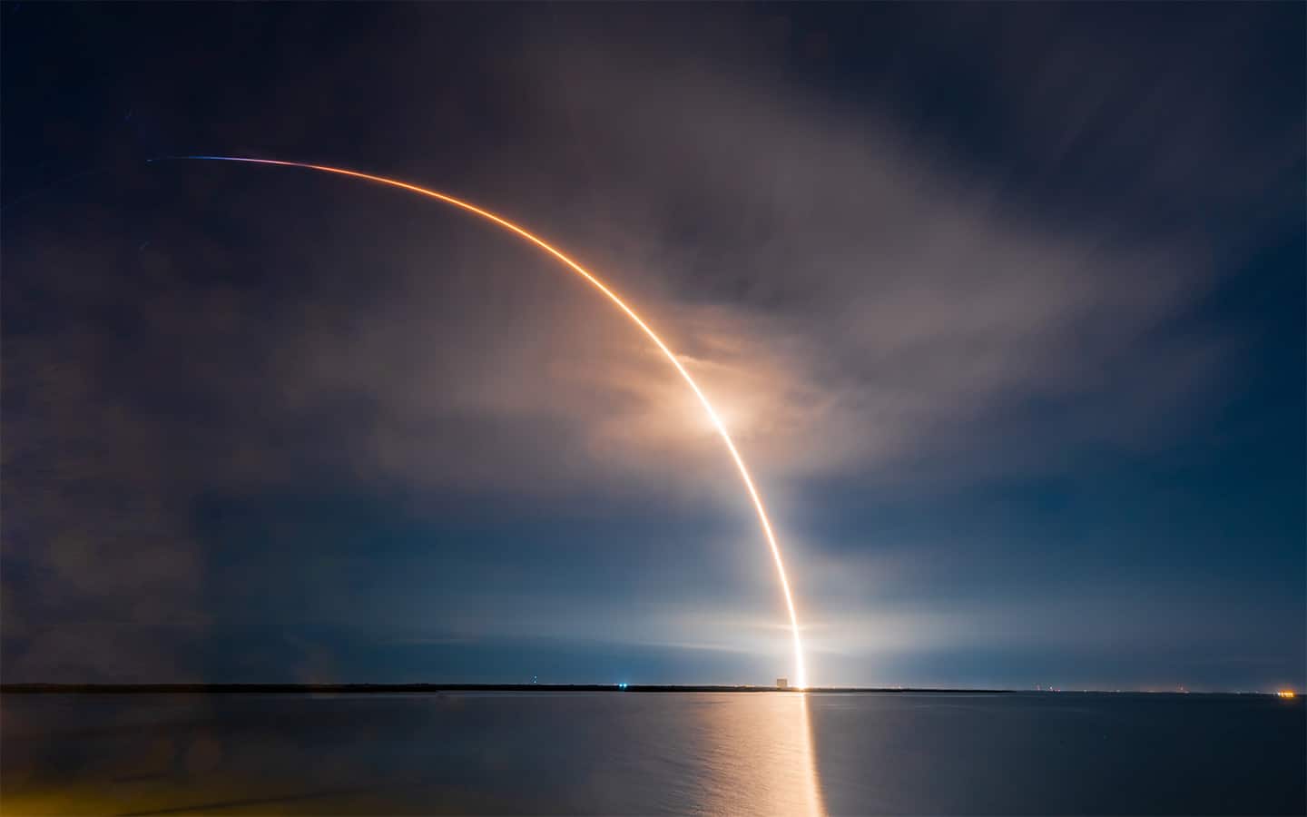 rocket seen in evening glow reaching the stratosphere